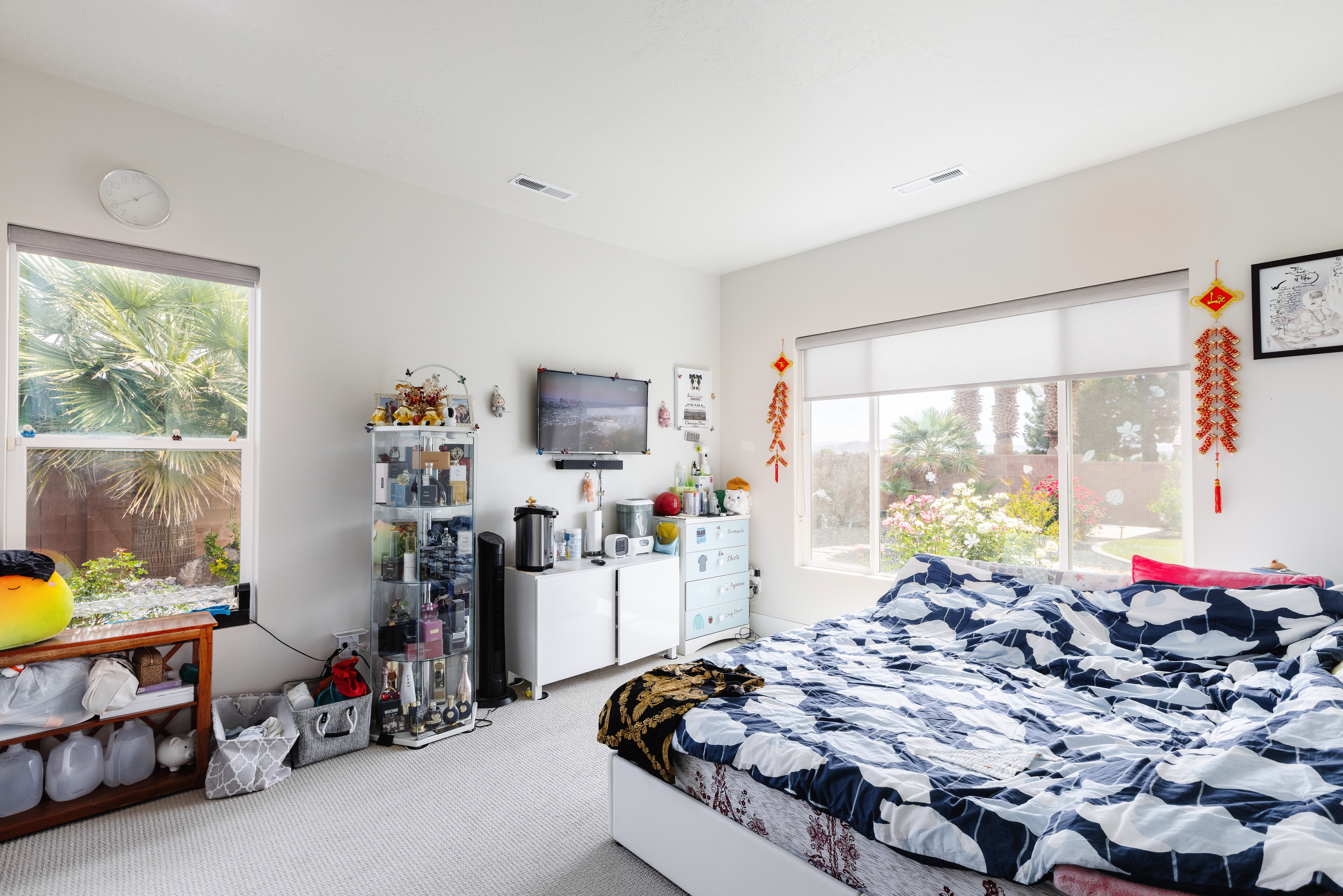 Bright room with two large windows, white walls, and light-colored carpet