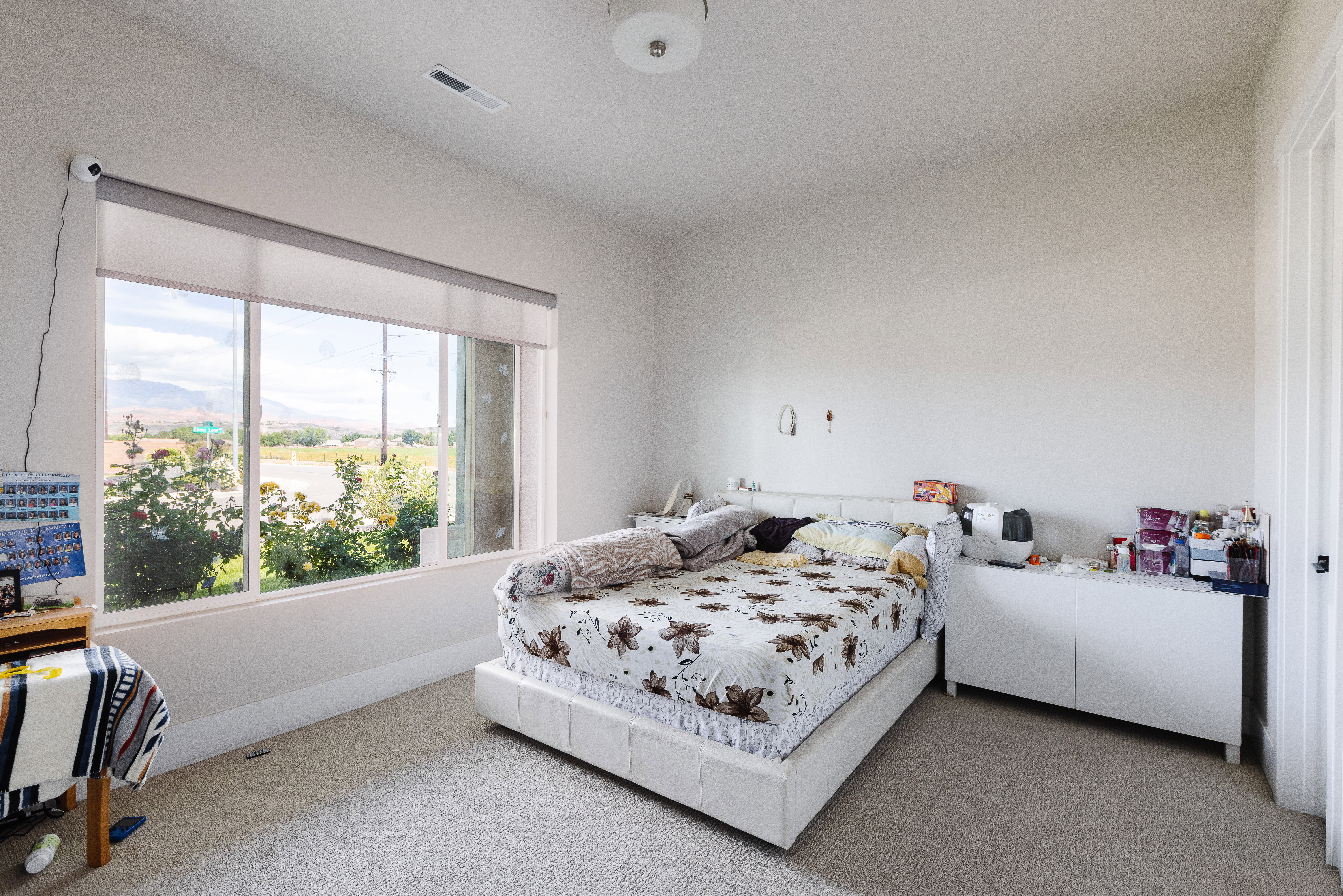 Bedroom with a large window and neutral wall finishes