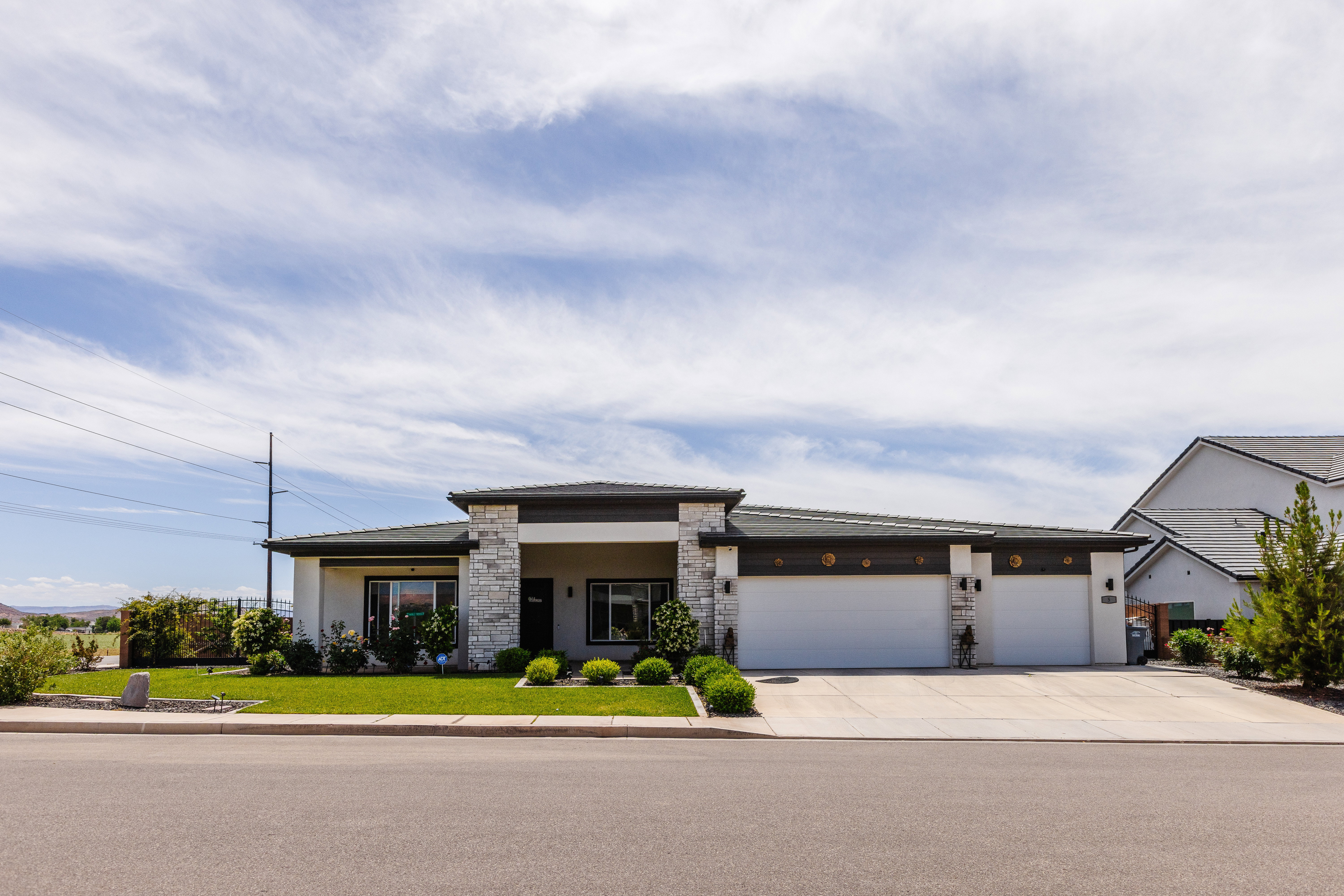 Contemporary single-story residence featuring a stone and stucco facade