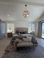 Vaulted shiplap ceiling featuring a geometric pendant light and recessed lighting