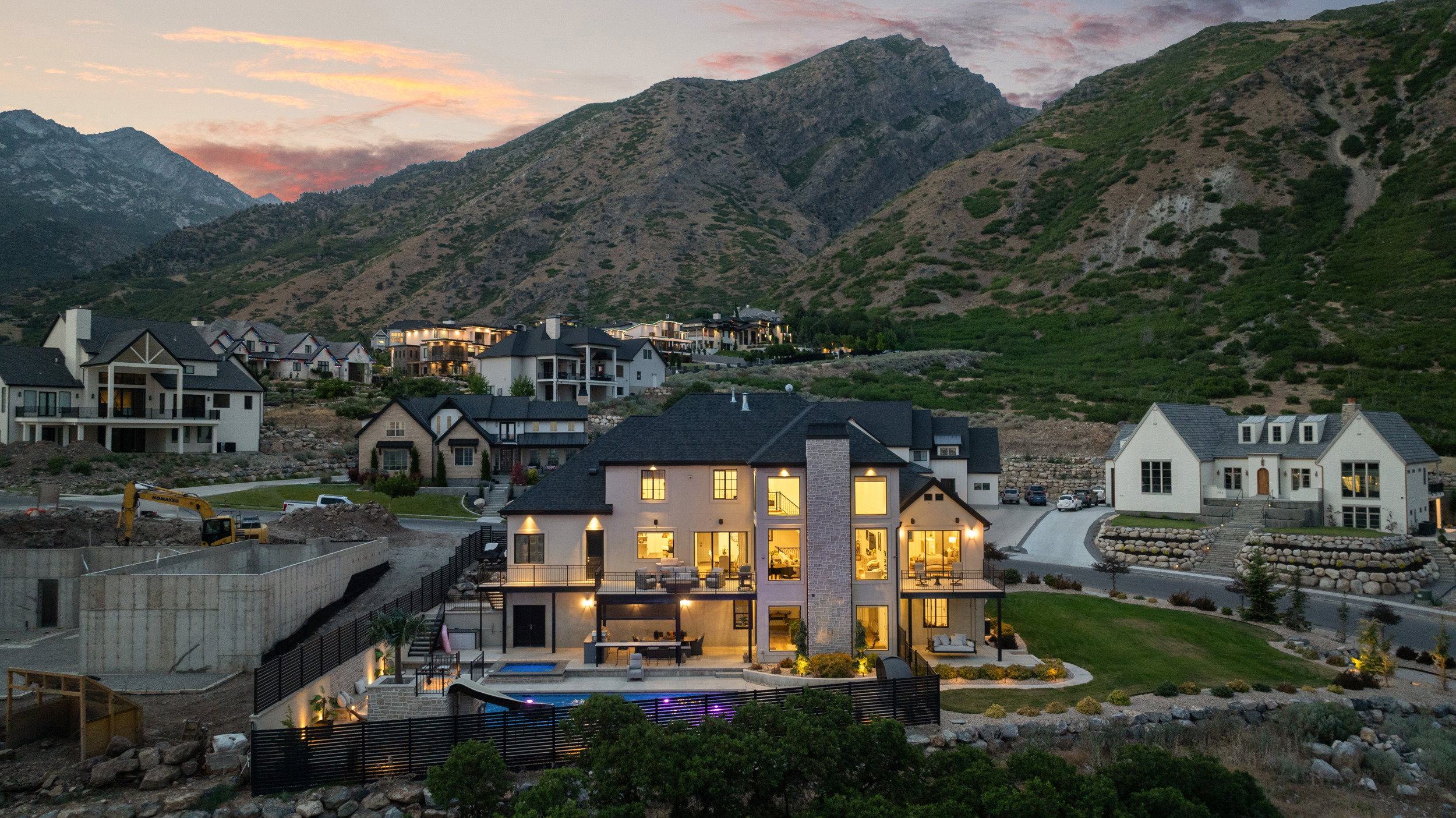 Stone and stucco exterior residence featuring multiple balconies and expansive windows