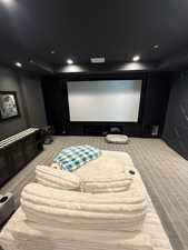 Dedicated media room featuring a large projection screen and integrated speaker system