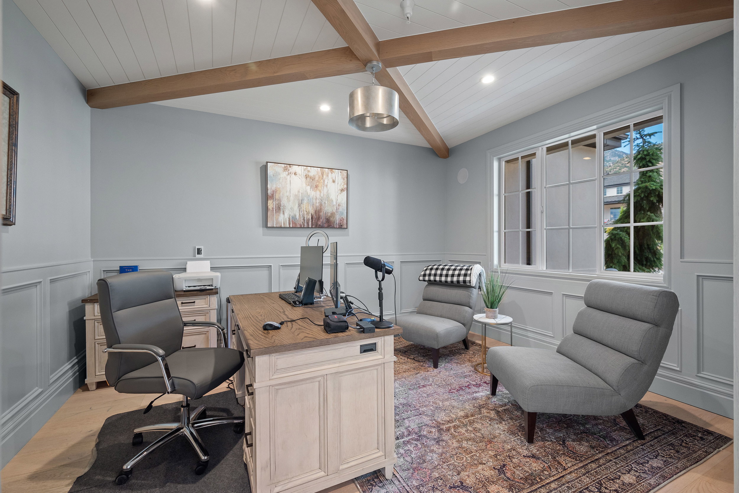 Vaulted ceiling with exposed wood beams and beadboard finish