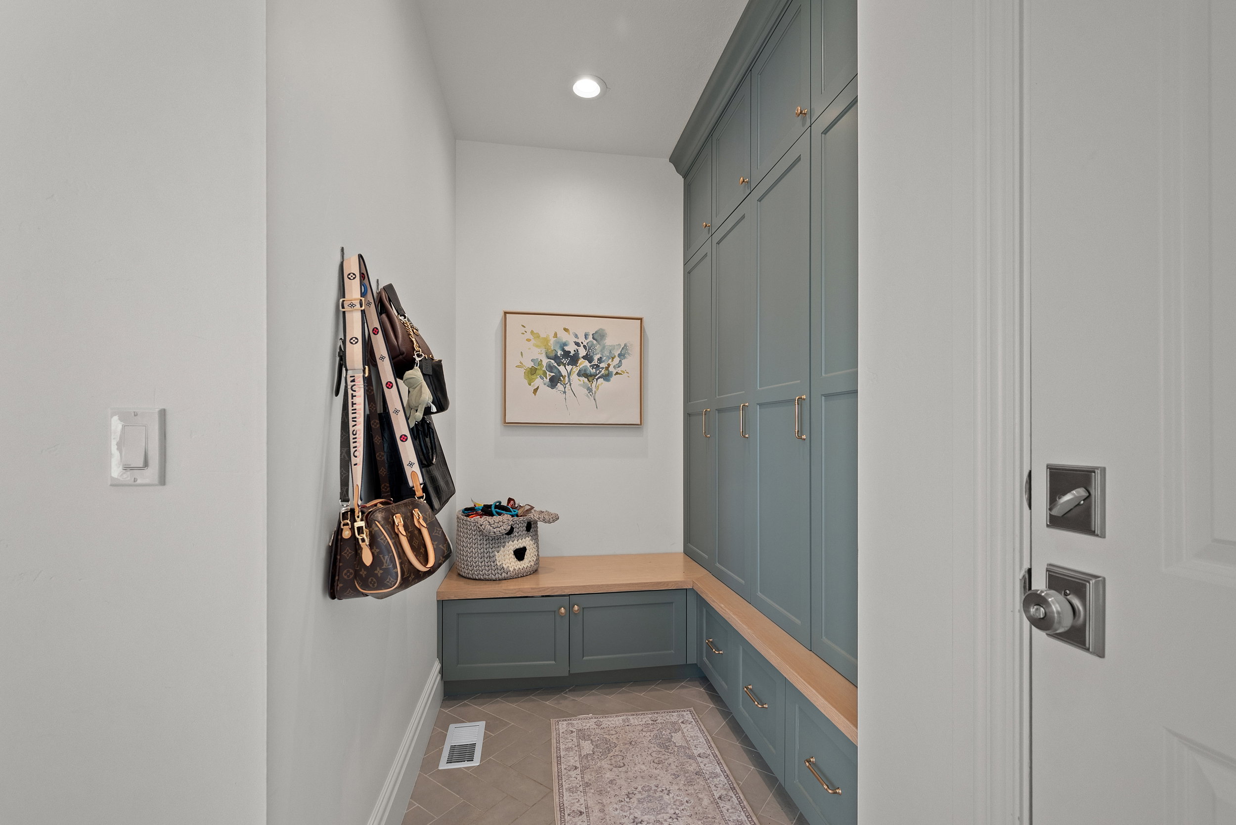 Mudroom with integrated storage cabinetry and a built-in bench