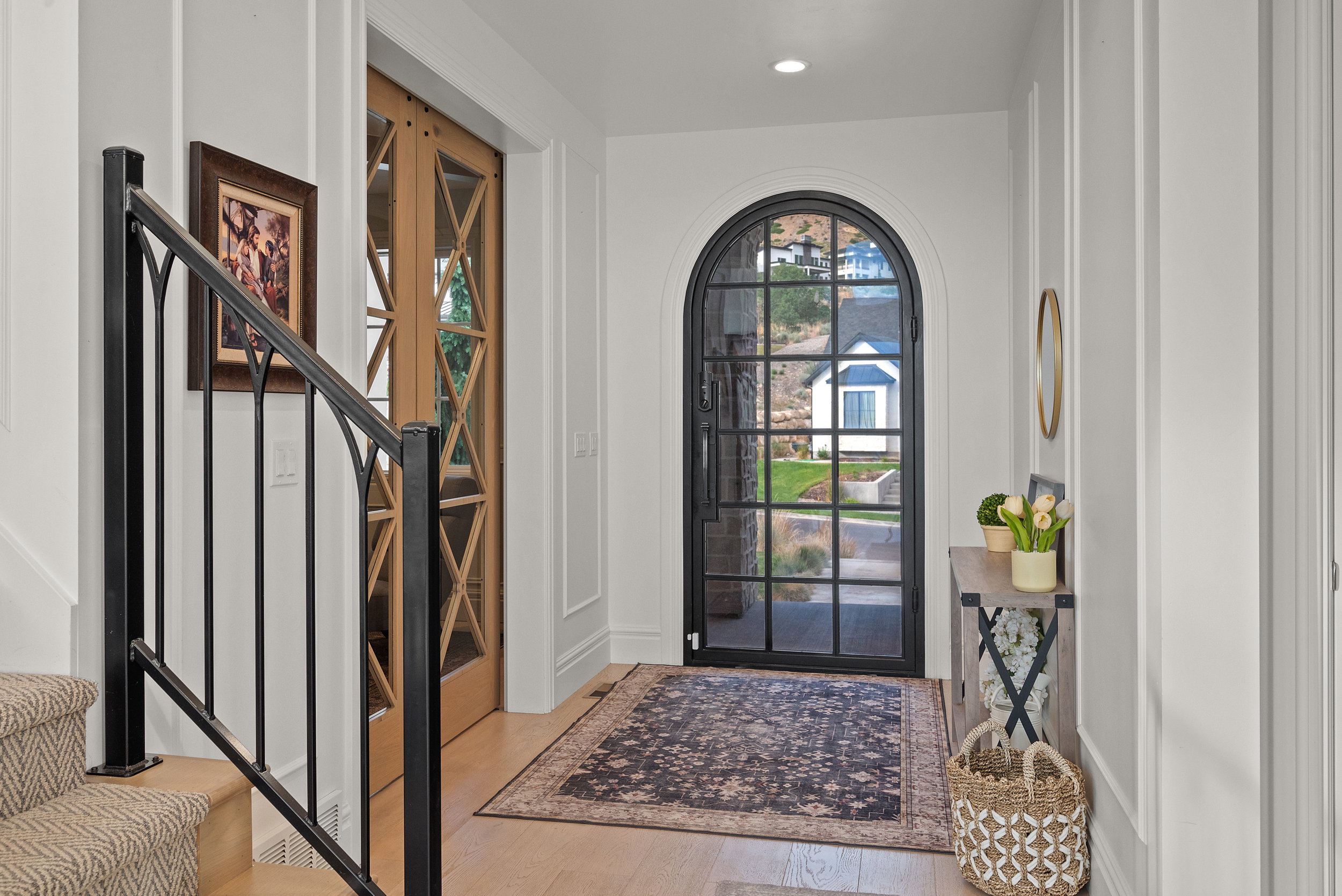 Arched glass and metal entry door with a multi-pane design