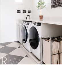 Dedicated laundry area featuring a checkerboard floor, built-in cabinetry, a countertop with an integrated sink, and a high-arc faucet