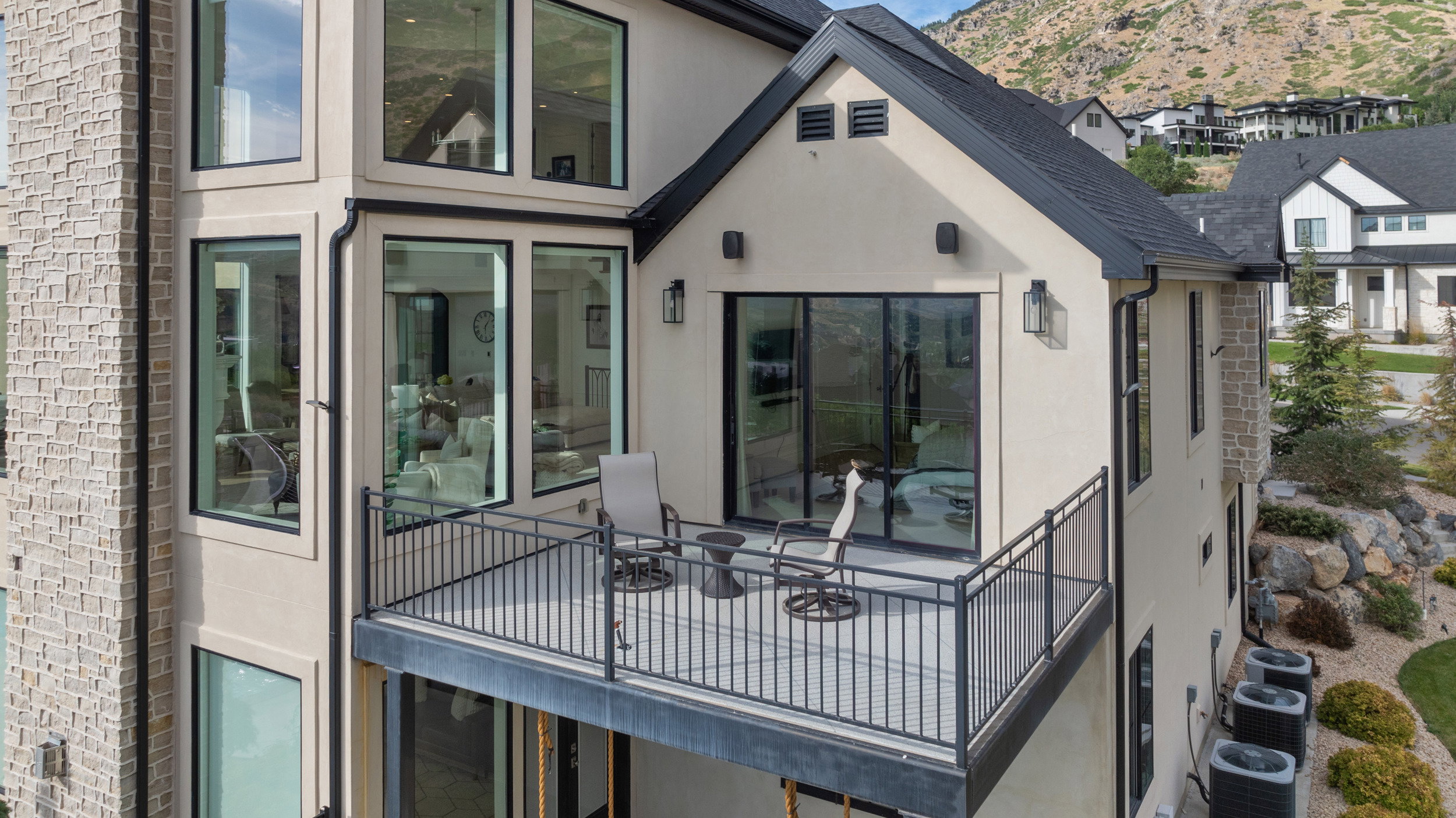Exterior balcony featuring dark metal railings and a glass sliding door