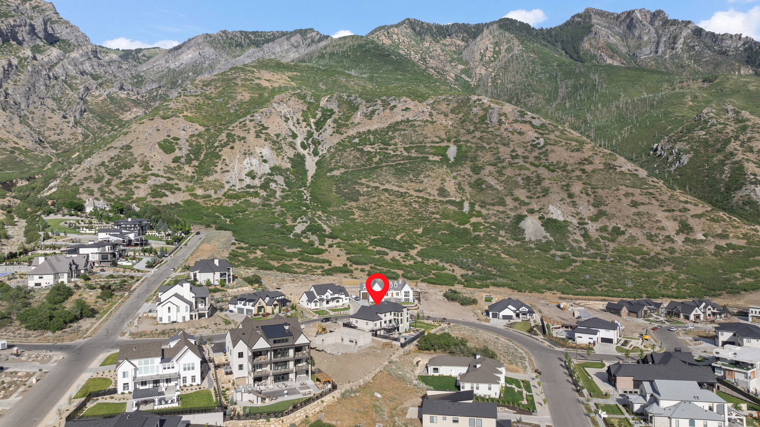 Mountainous backdrop framing a residential community with contemporary homes