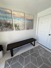 White paneled interior door with a dark knob, set against a white wall with crown molding