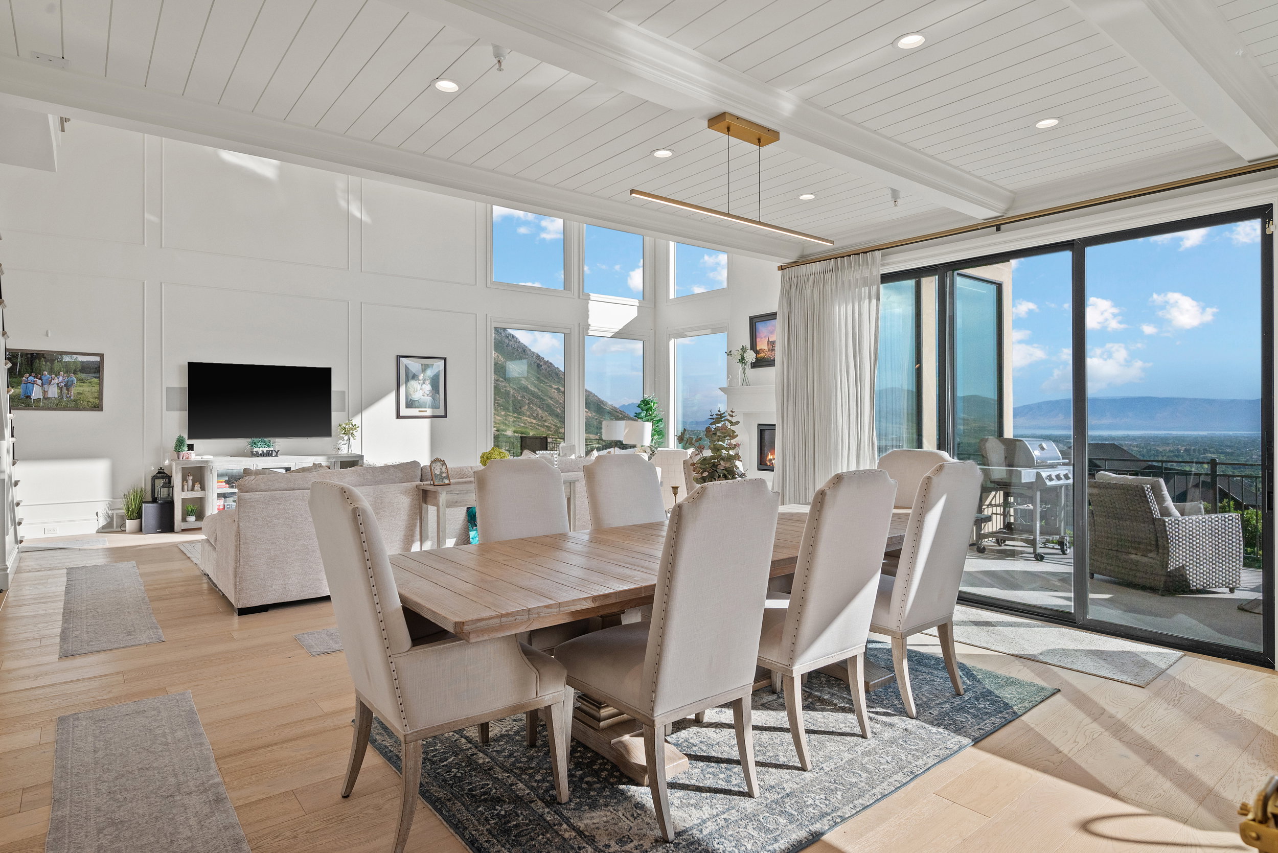 Expansive open-concept living space with high ceilings and wood-finish flooring