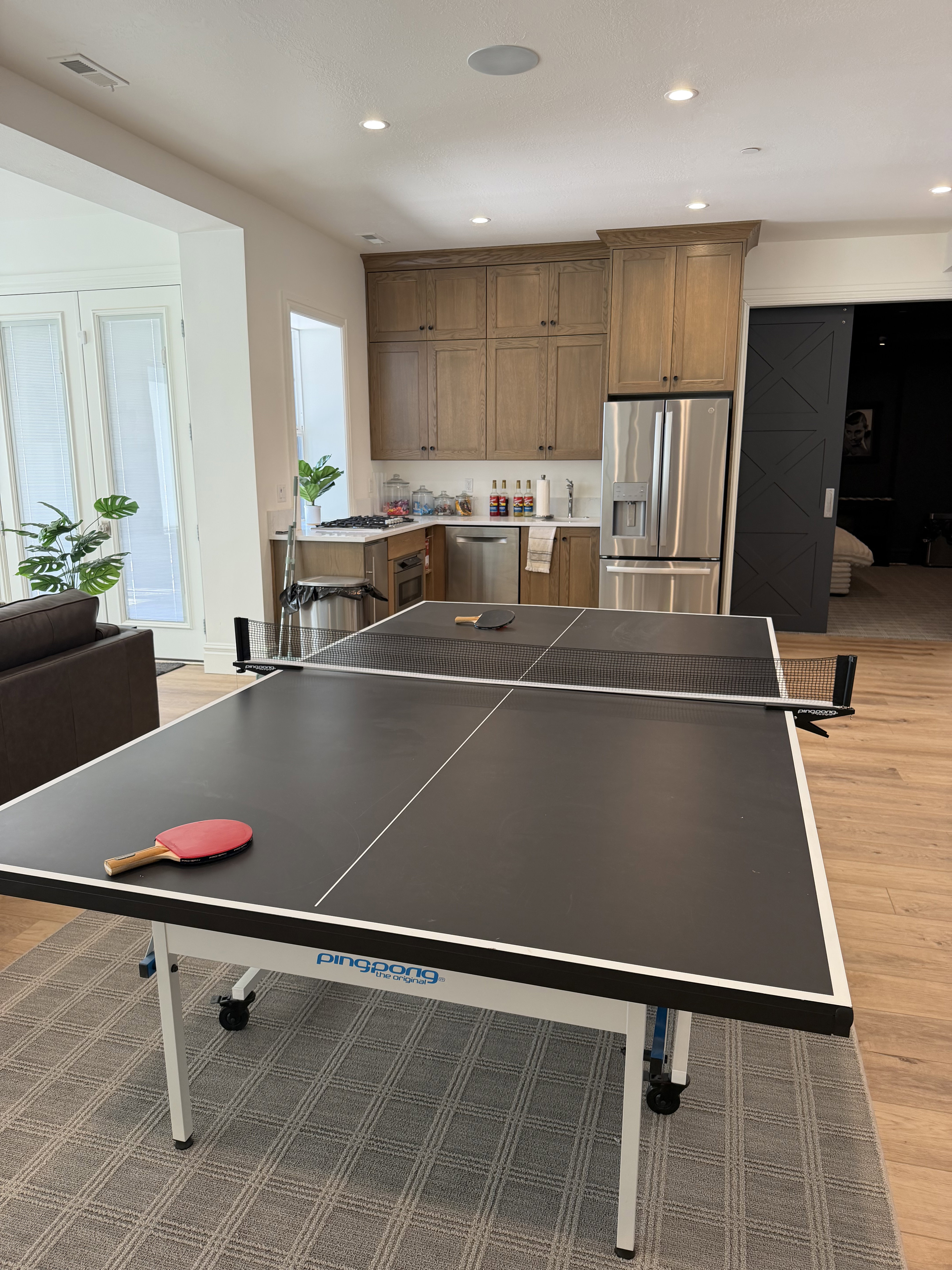 Open-concept living area with wood-finish flooring, recessed lighting, and a neutral color palette