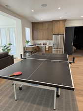 Open-concept living area with wood-finish flooring, recessed lighting, and a neutral color palette
