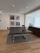 Spacious room featuring wood-finish flooring, recessed lighting, and large windows