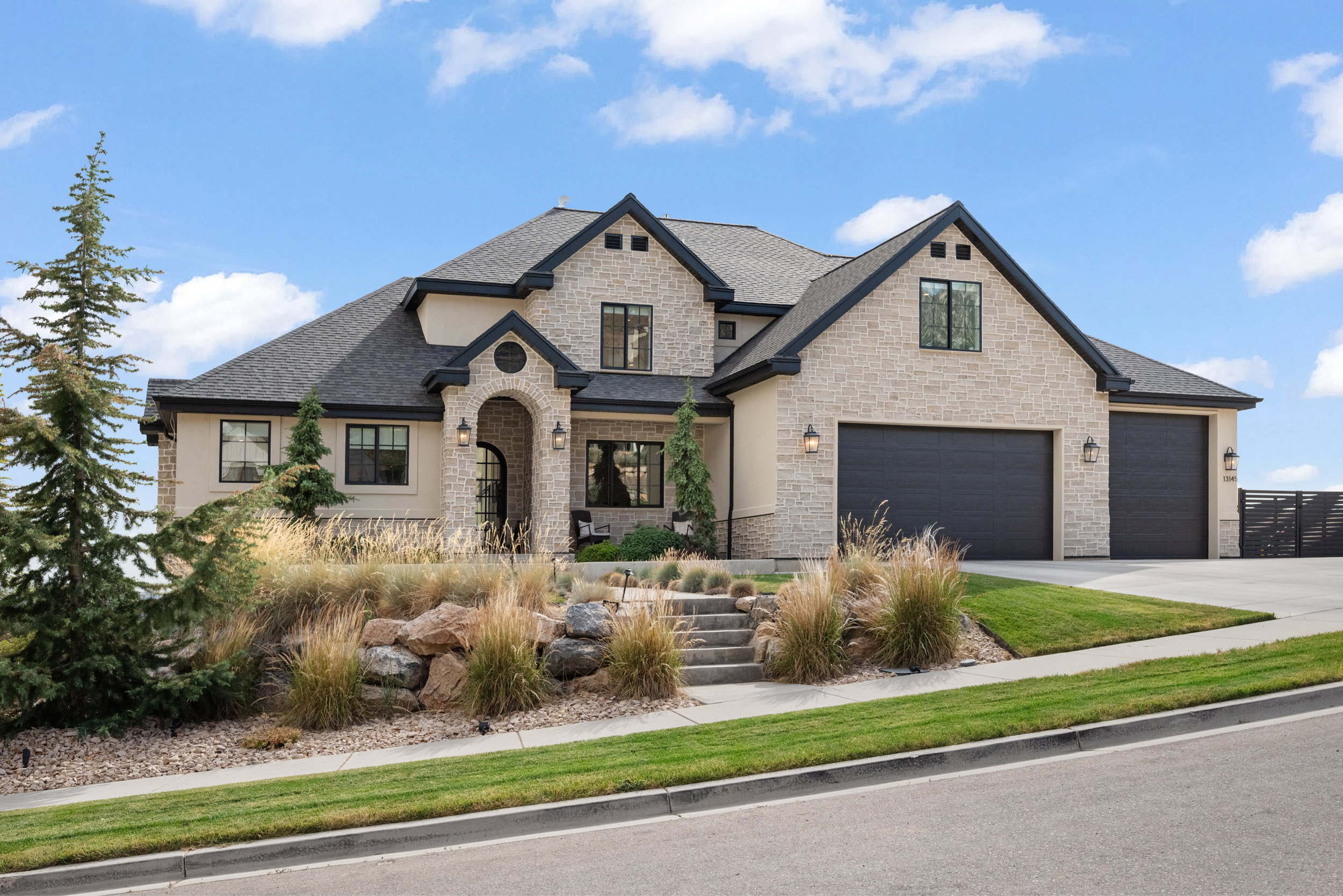 Stucco and stone facade with dark trim accents