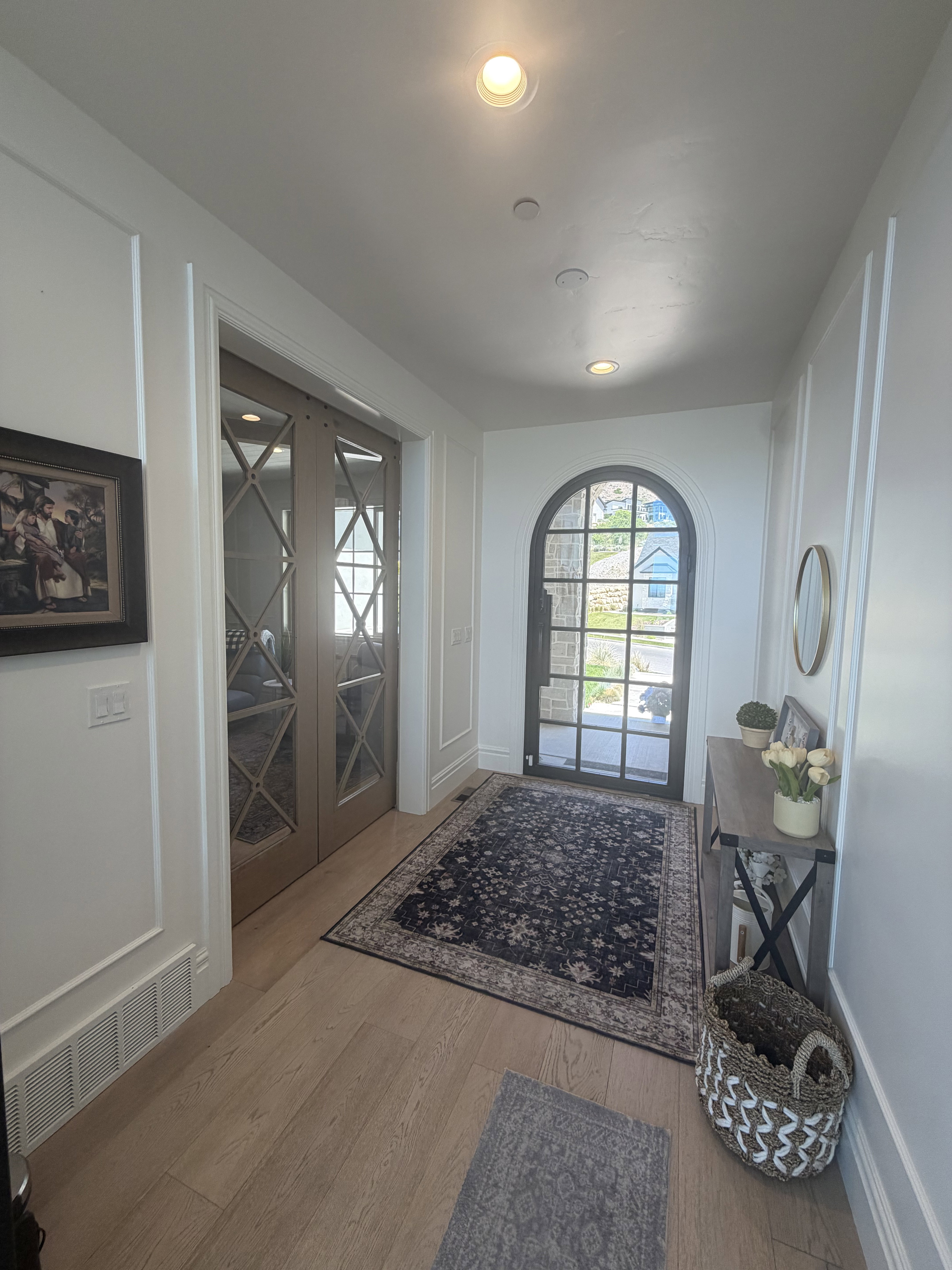 Entryway featuring light wood-finish flooring, recessed lighting, and white wainscoting