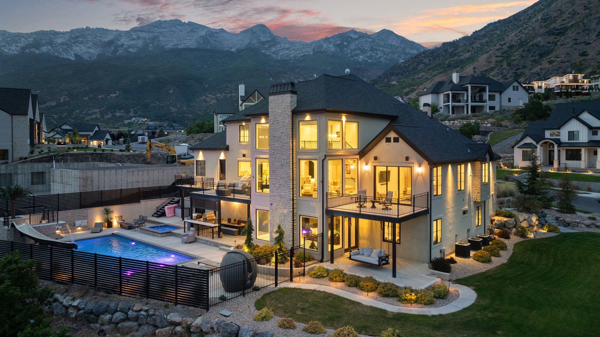 Contemporary residence featuring a multi-level design with a stucco exterior and dark-toned roof