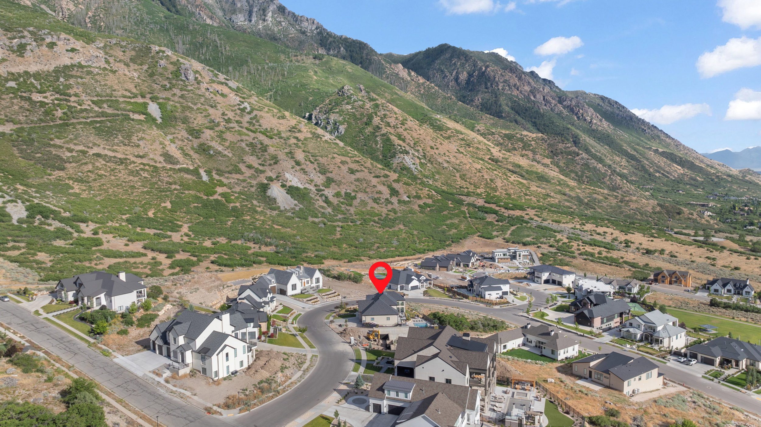 Residential property on an elevated lot with a mountain backdrop