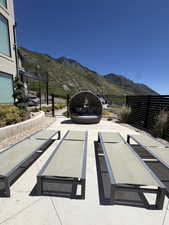 Expansive patio area featuring stamped concrete, multiple lounge chairs, and a circular daybed