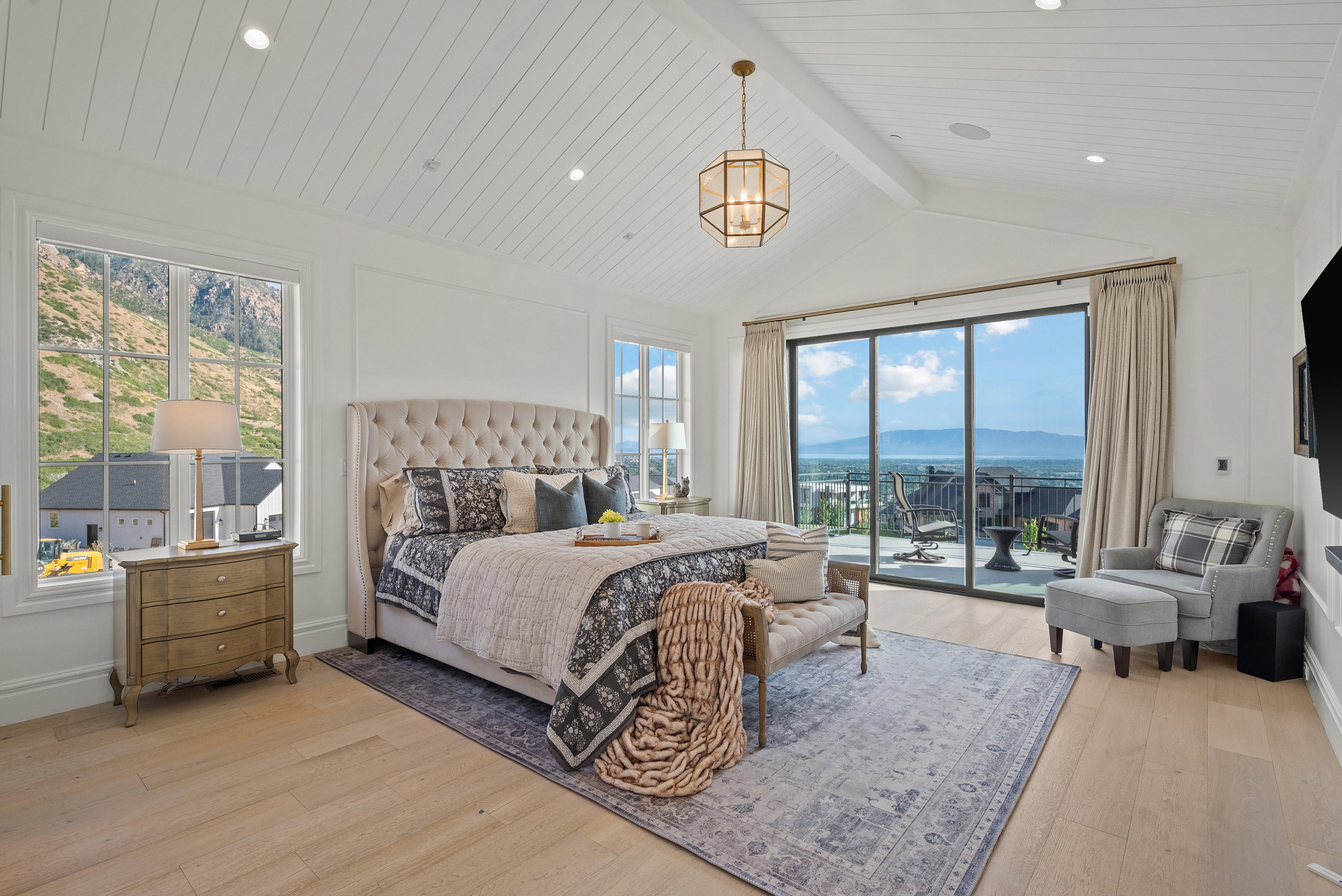 Spacious room featuring vaulted shiplap ceilings and wood-finish flooring