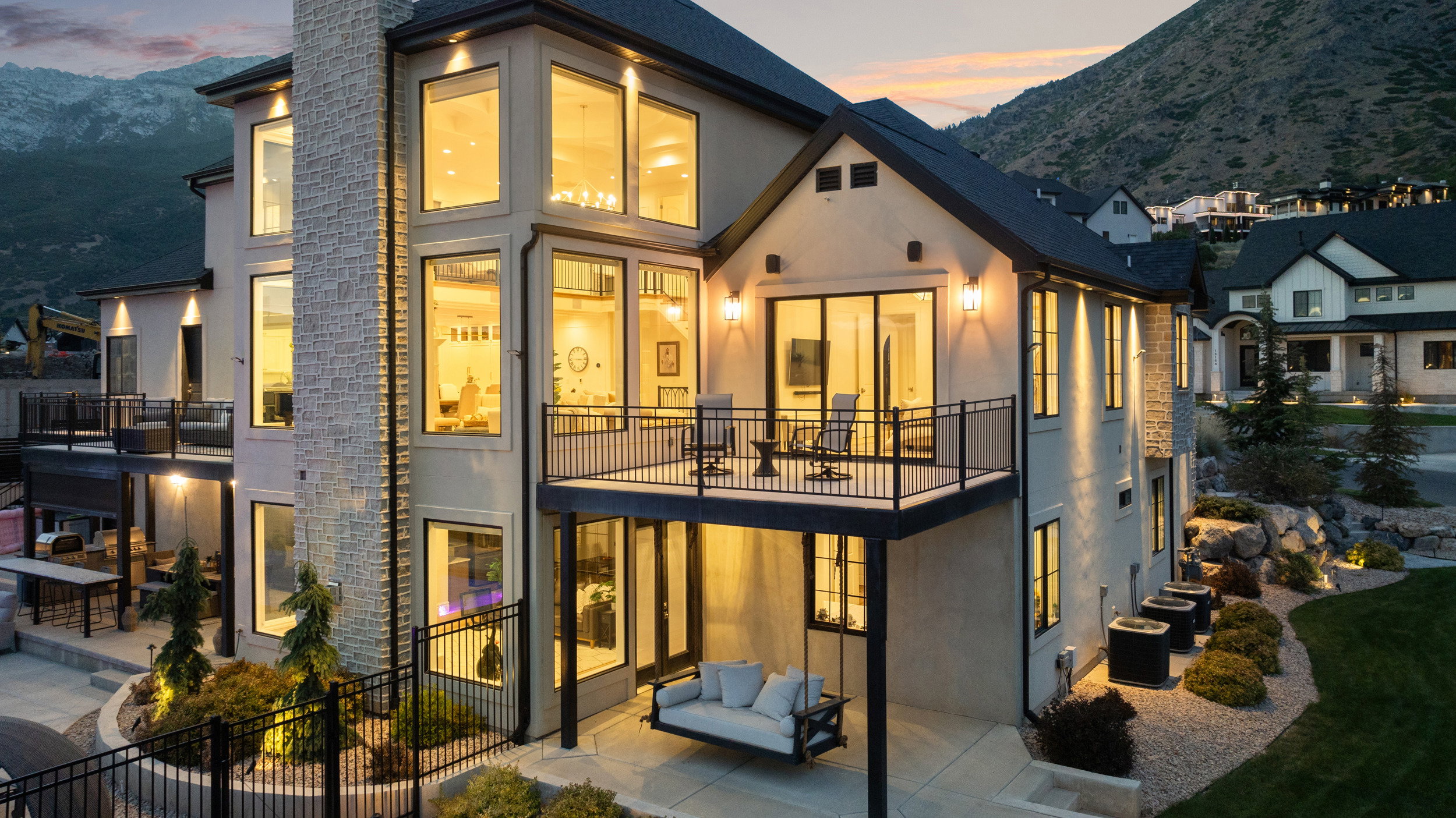 Contemporary residence featuring a multi-story exterior with stucco and stone accents