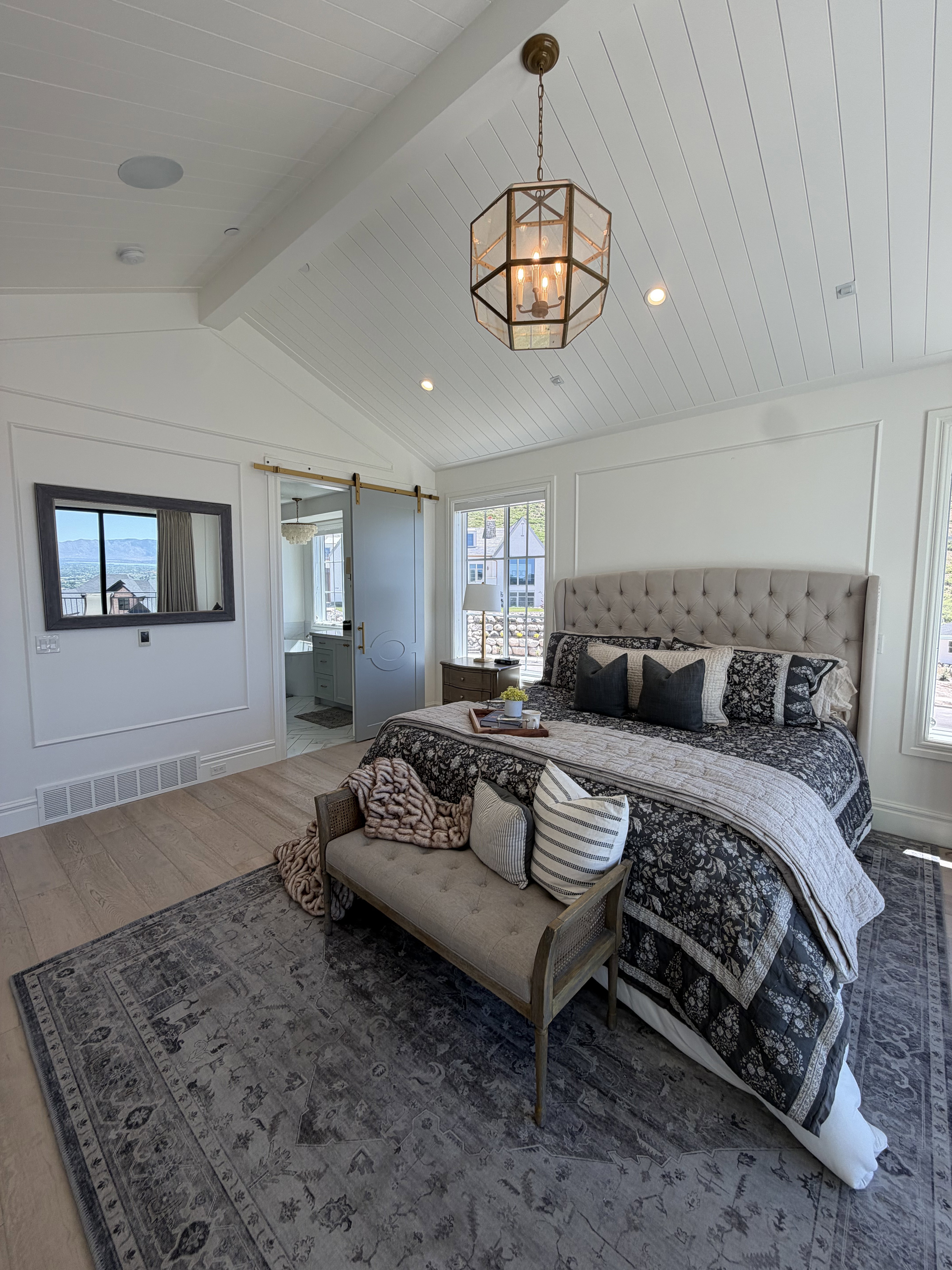 Vaulted shiplap ceiling featuring a geometric brass chandelier and recessed lighting