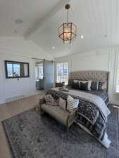 Vaulted shiplap ceiling featuring a geometric brass chandelier and recessed lighting
