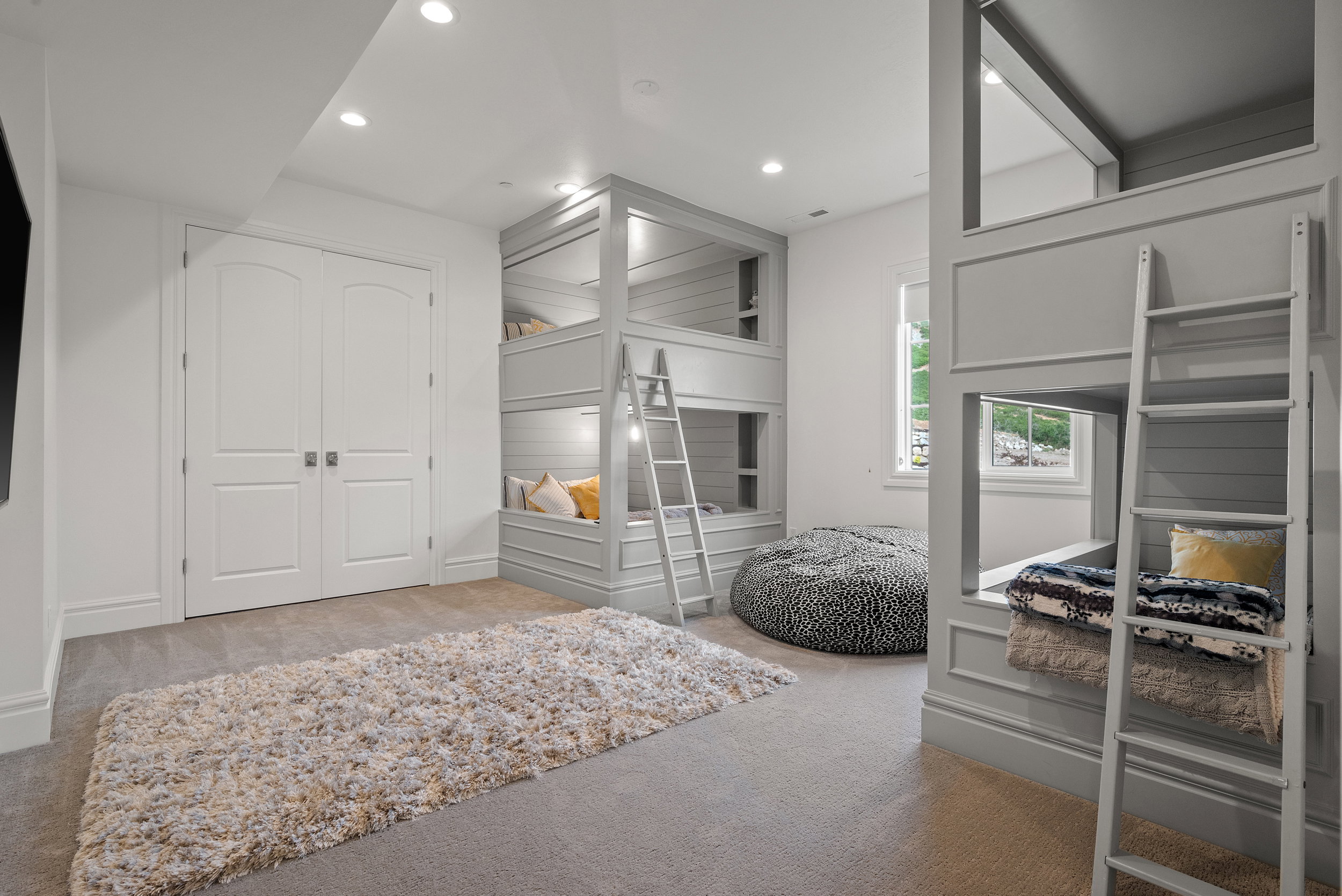 Built-in bunk beds with integrated lighting and shiplap accents