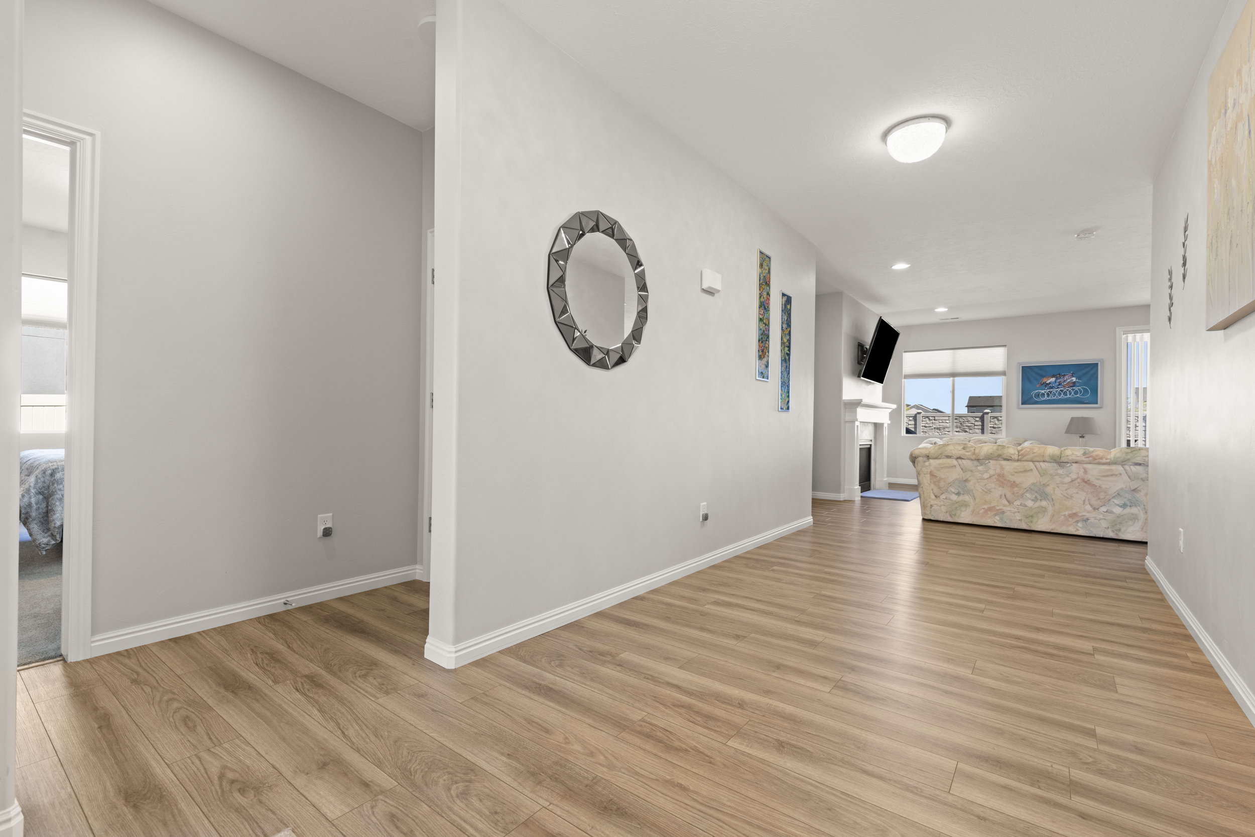 Light wood-finish flooring extending from the hallway into the living area