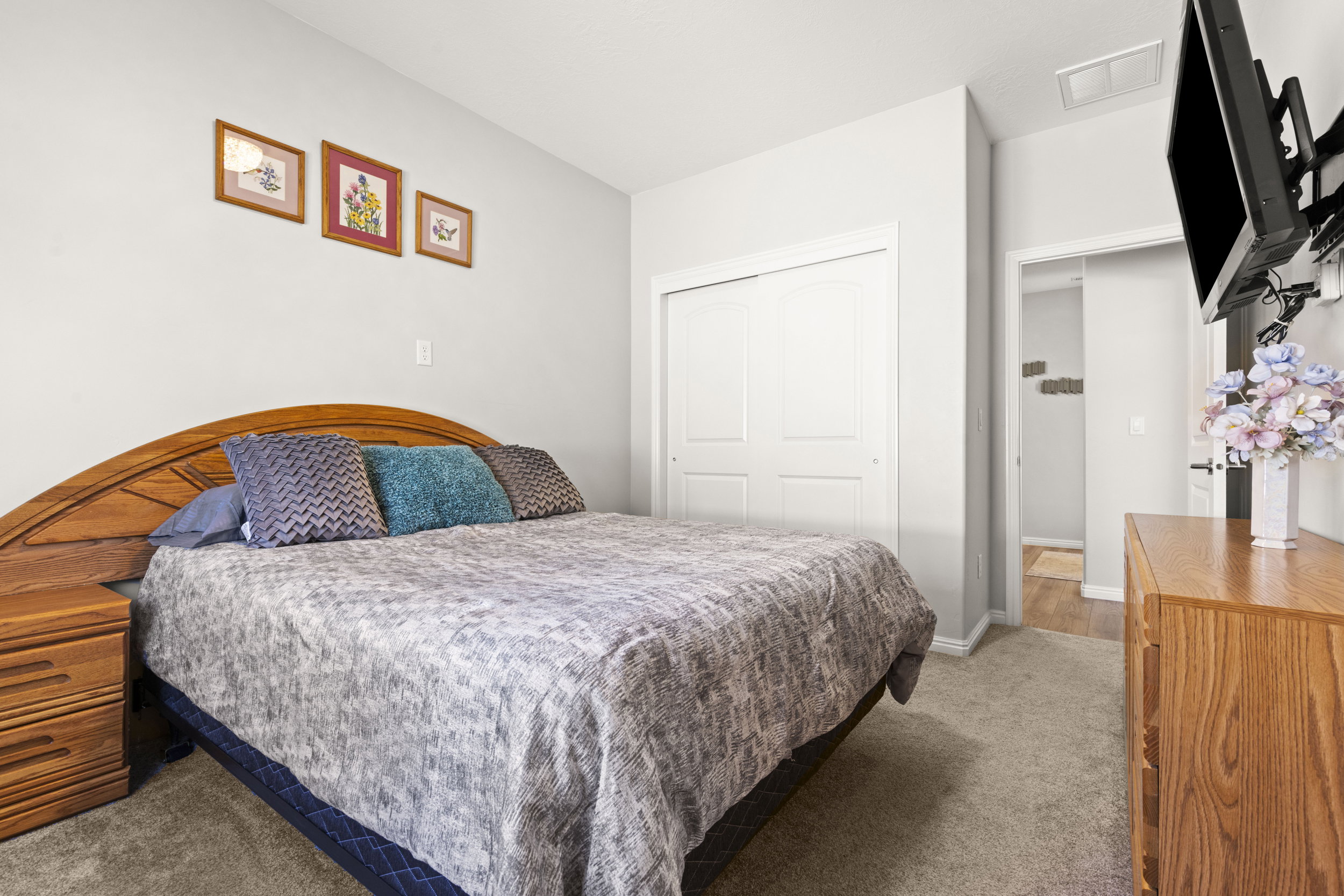 Bedroom featuring carpet flooring and a closet with bifold doors