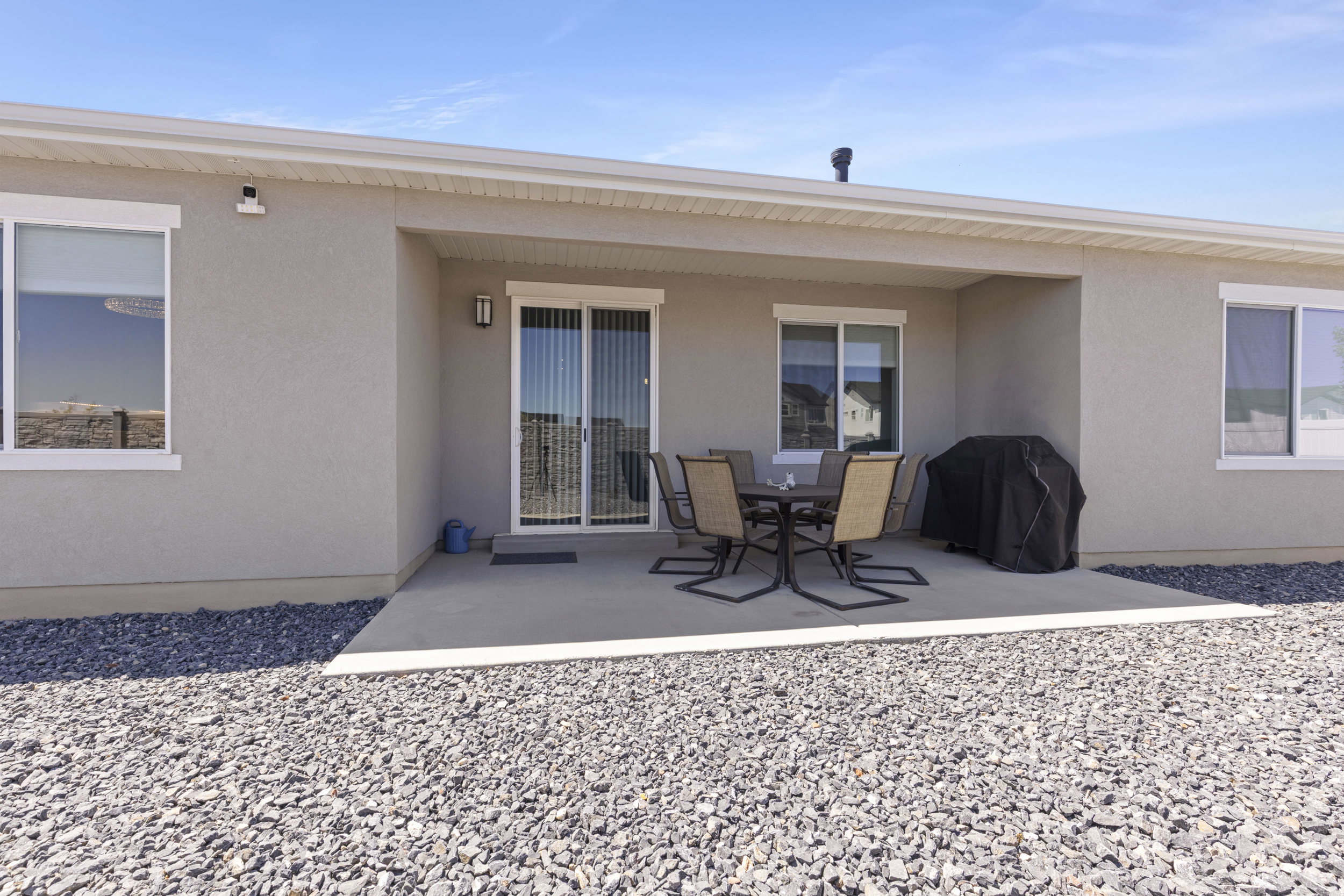 Covered patio featuring a concrete slab and access via sliding glass doors