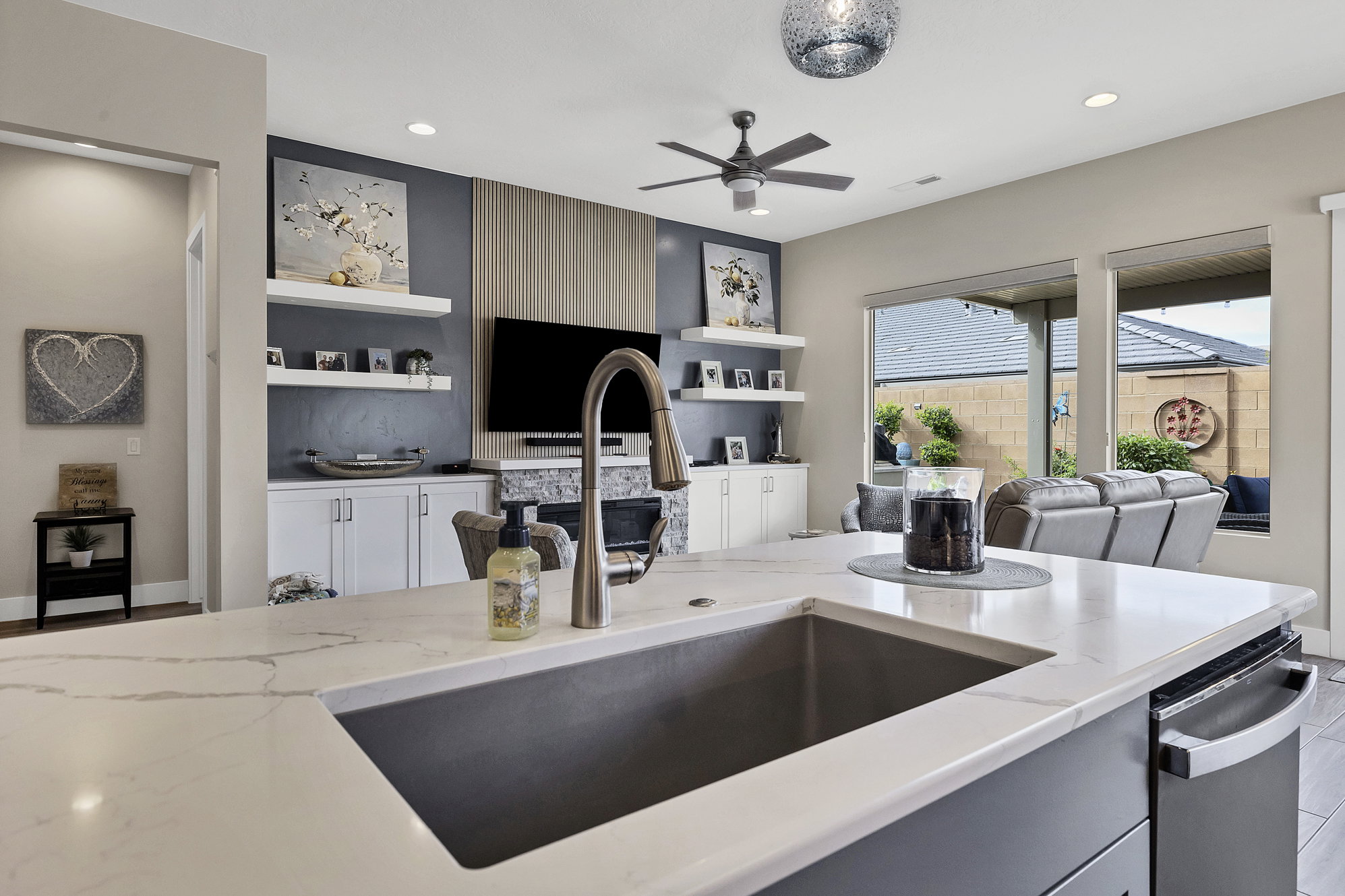 Kitchen island featuring a substantial undermount sink and a gooseneck faucet