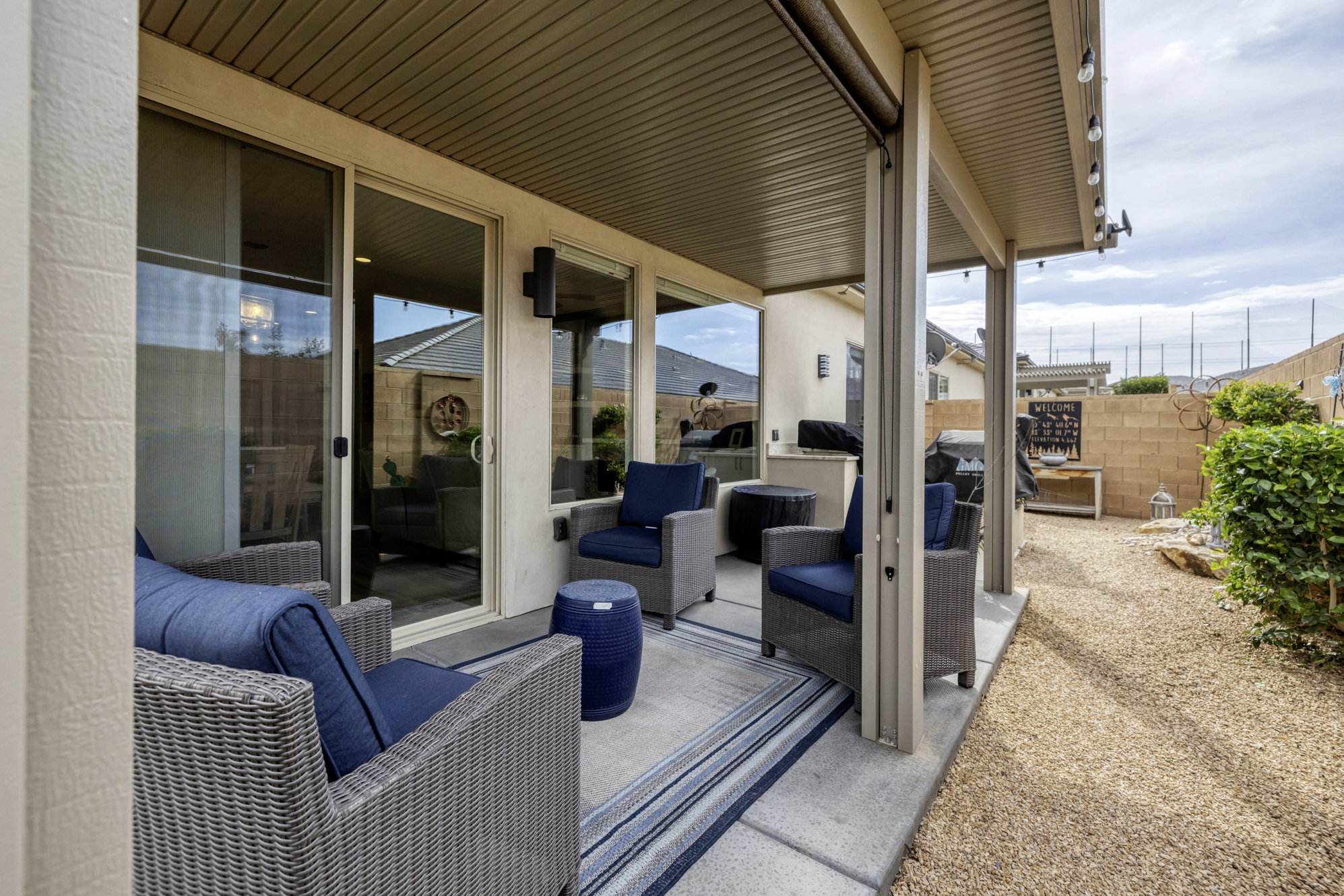 Covered patio with concrete flooring and overhead string lighting