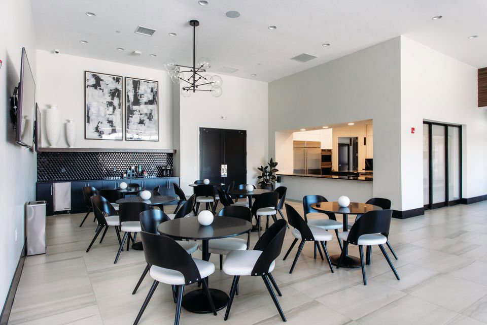 Spacious common area featuring high ceilings, recessed lighting, and large format tile flooring