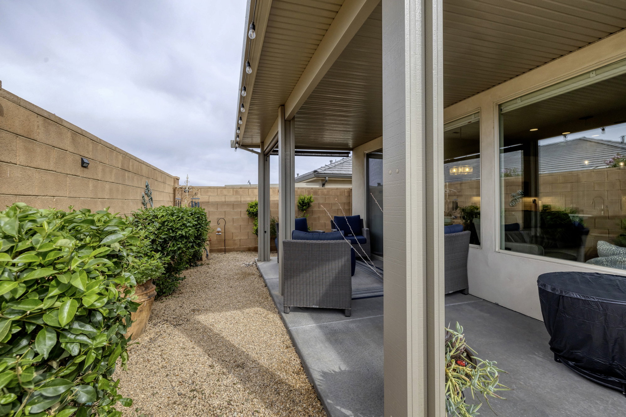 Covered patio featuring concrete flooring and integrated overhead lighting
