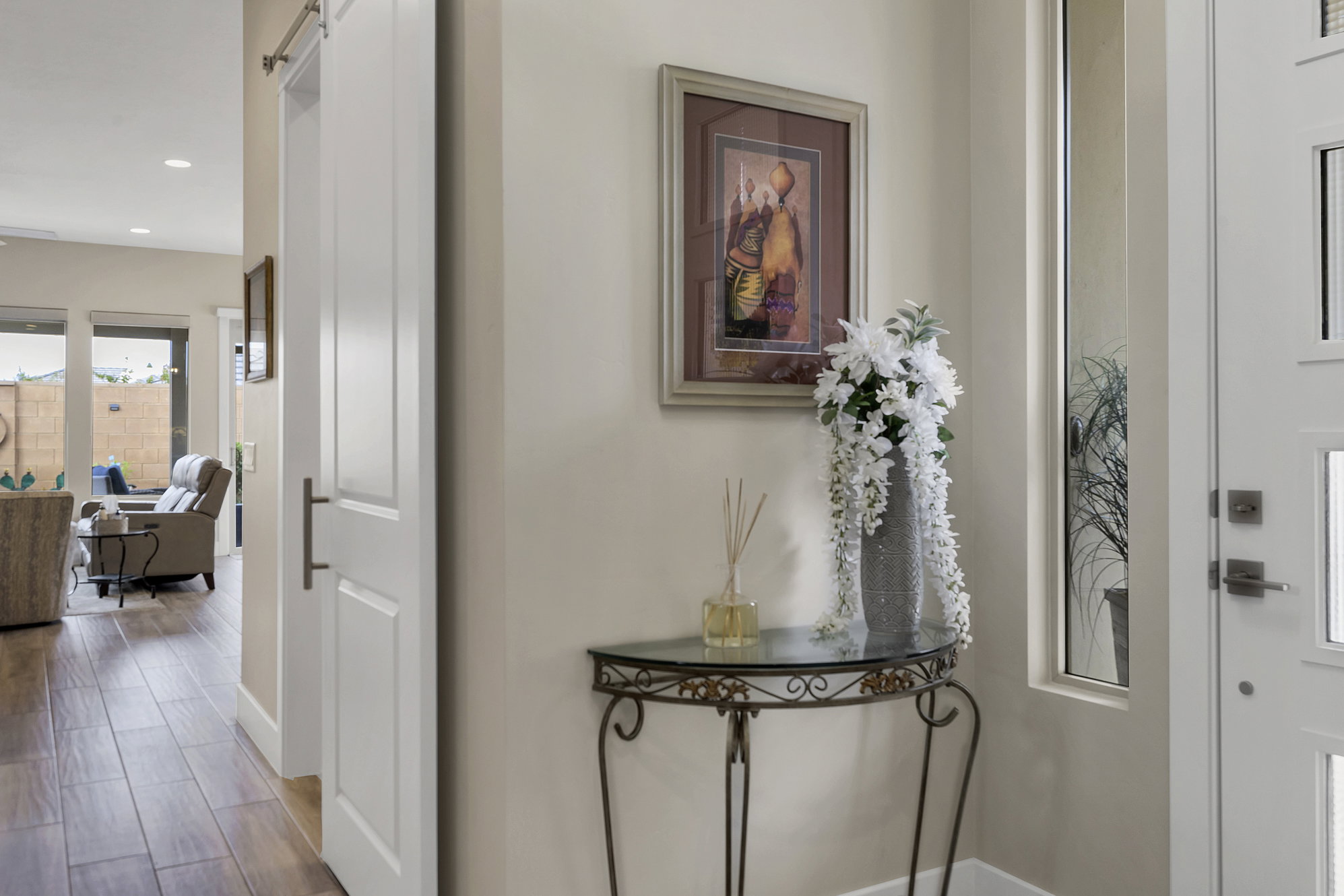 Entryway featuring a white paneled door with frosted glass inserts, sidelight, and wood-finish flooring