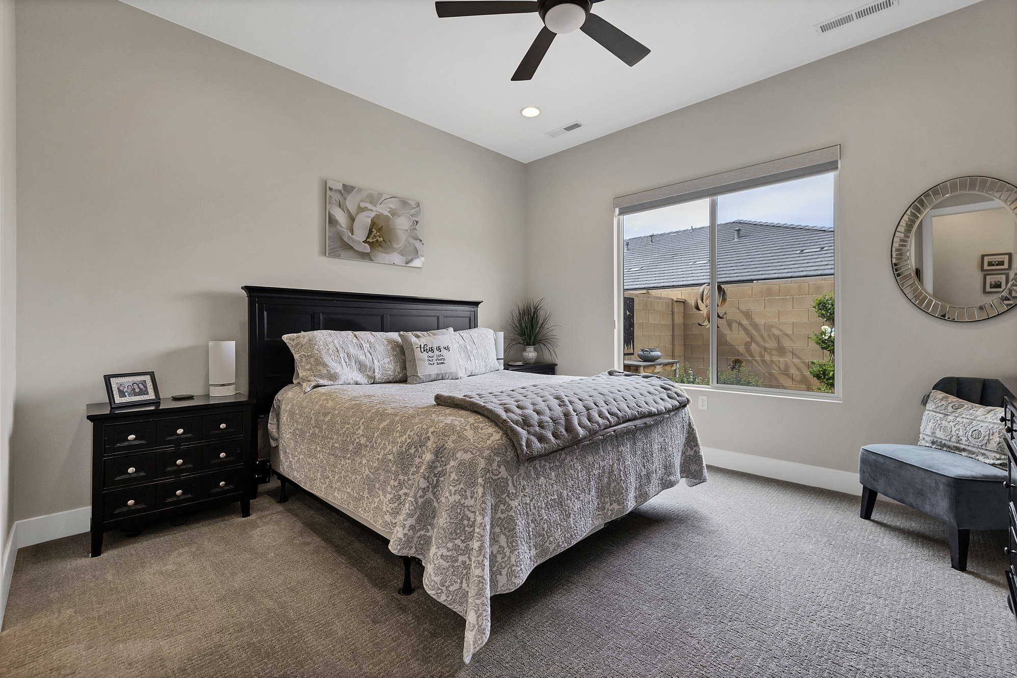 Carpeted room featuring a large window, recessed lighting, and a ceiling fan