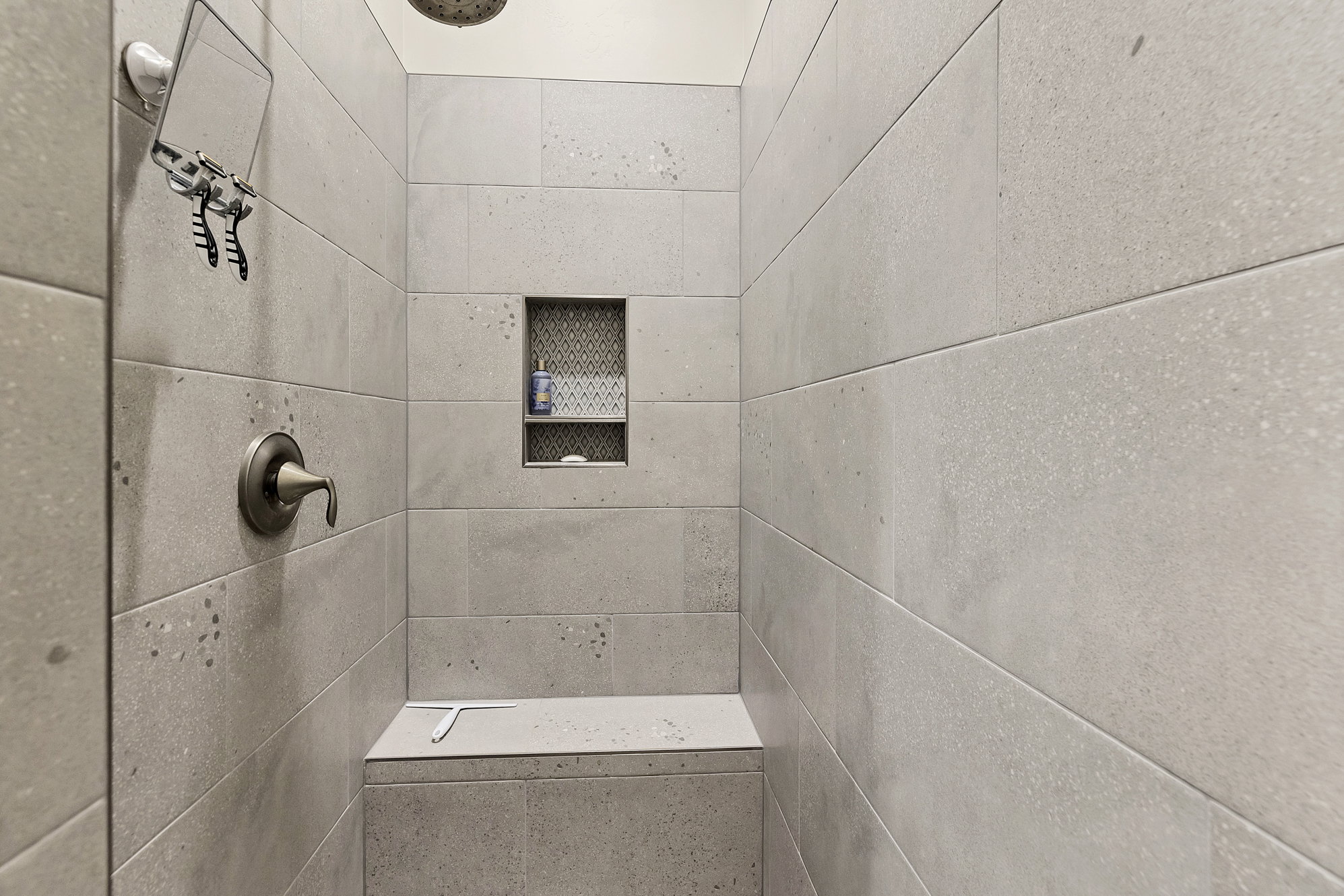 Walk-in shower with large-format light grey wall tiling