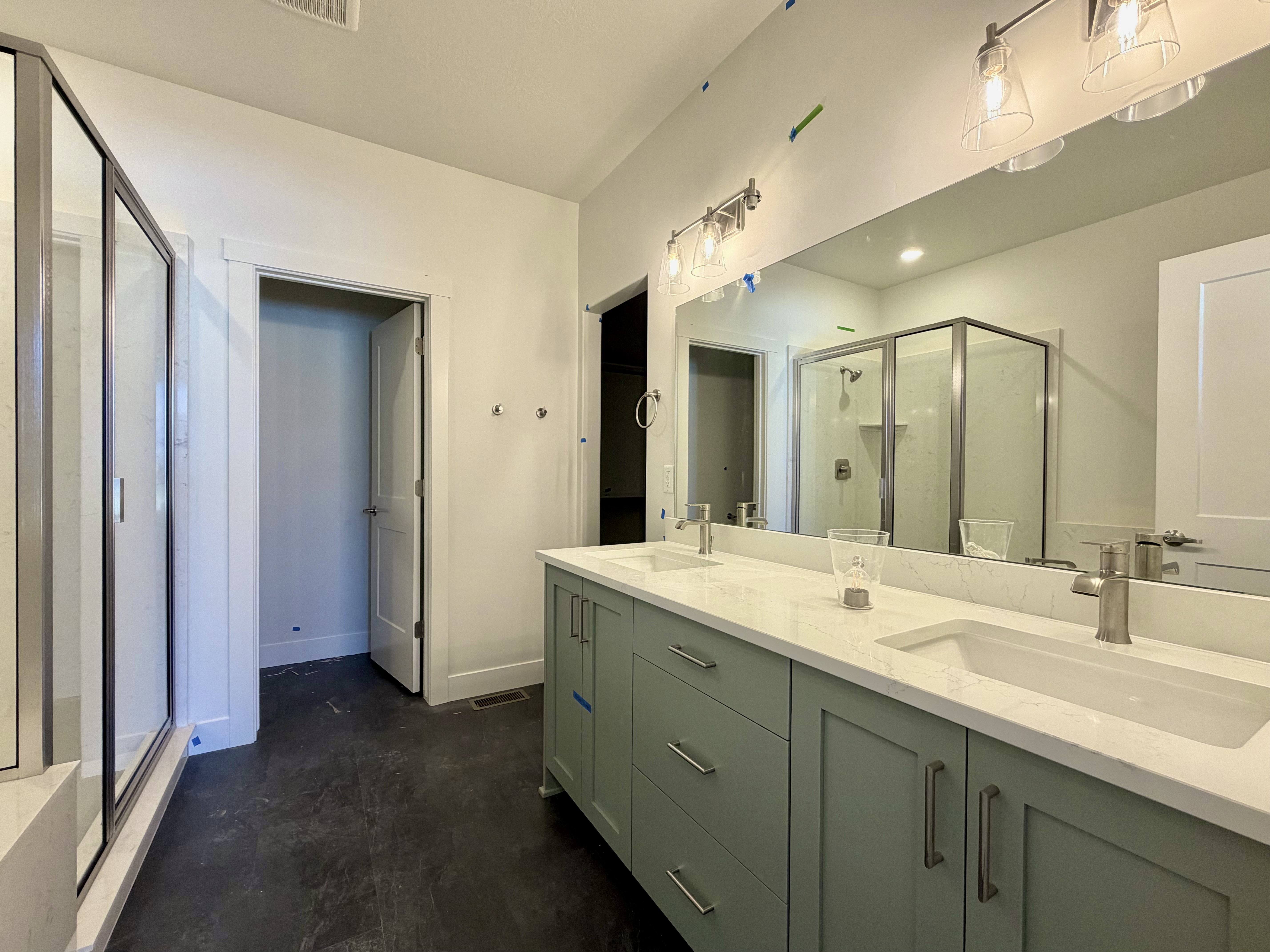 Double vanity featuring dual undermount sinks, stone countertops, and brushed nickel fixtures