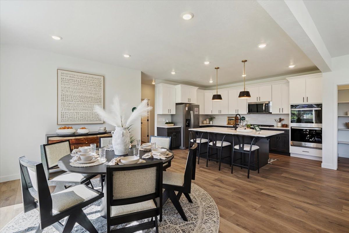 Open-concept living space featuring wood-finish flooring, recessed lighting, and a white ceiling