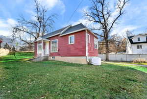 Red siding exterior with white trim windows and a covered entry