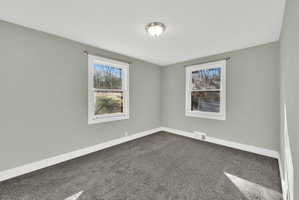 Light gray interior paint tones complement the dark gray carpeting