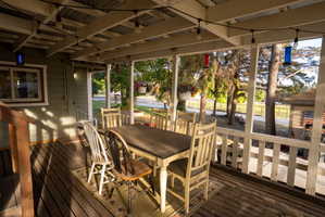 Covered outdoor patio featuring a corrugated metal roof and exposed wood beams