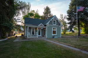 Traditional two-story exterior with a covered porch, gabled roofline, and dormer window