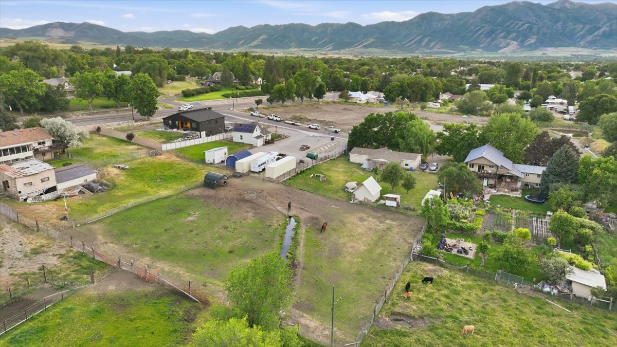 Expansive property featuring green pastures, established fencing, and a natural water channel