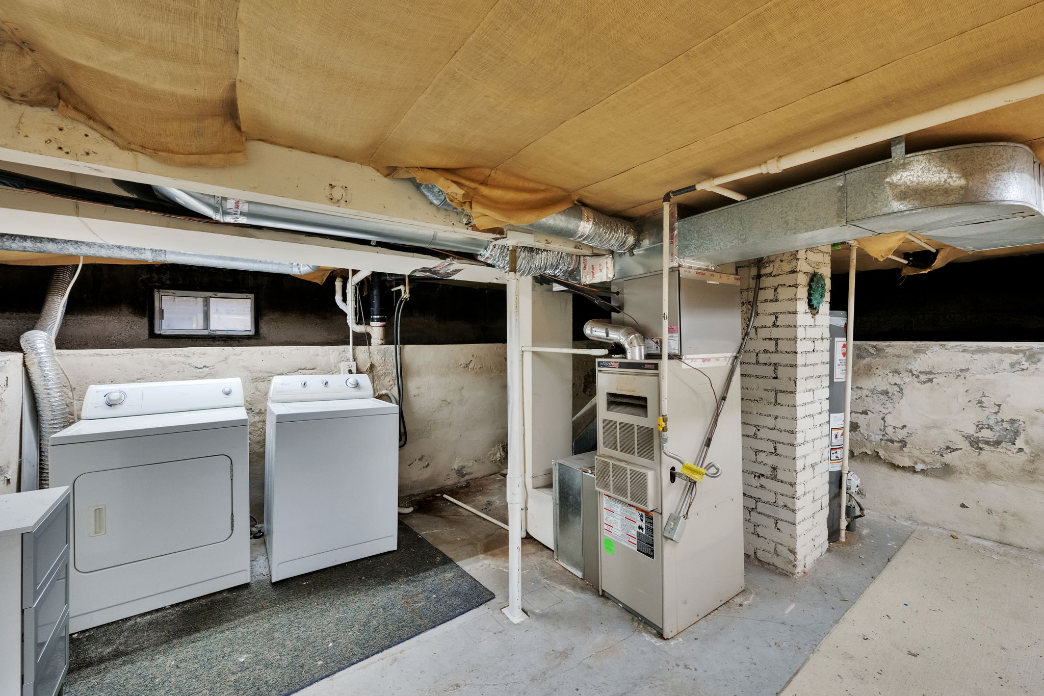 Utility space featuring a washer, dryer, furnace, and water heater
