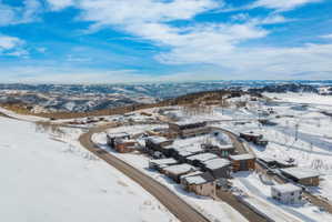 Snowy aerial view featuring a mountain view