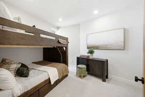 Spacious room featuring light-toned carpeting and recessed lighting