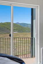 Sliding glass door opening to a private balcony with metal railing