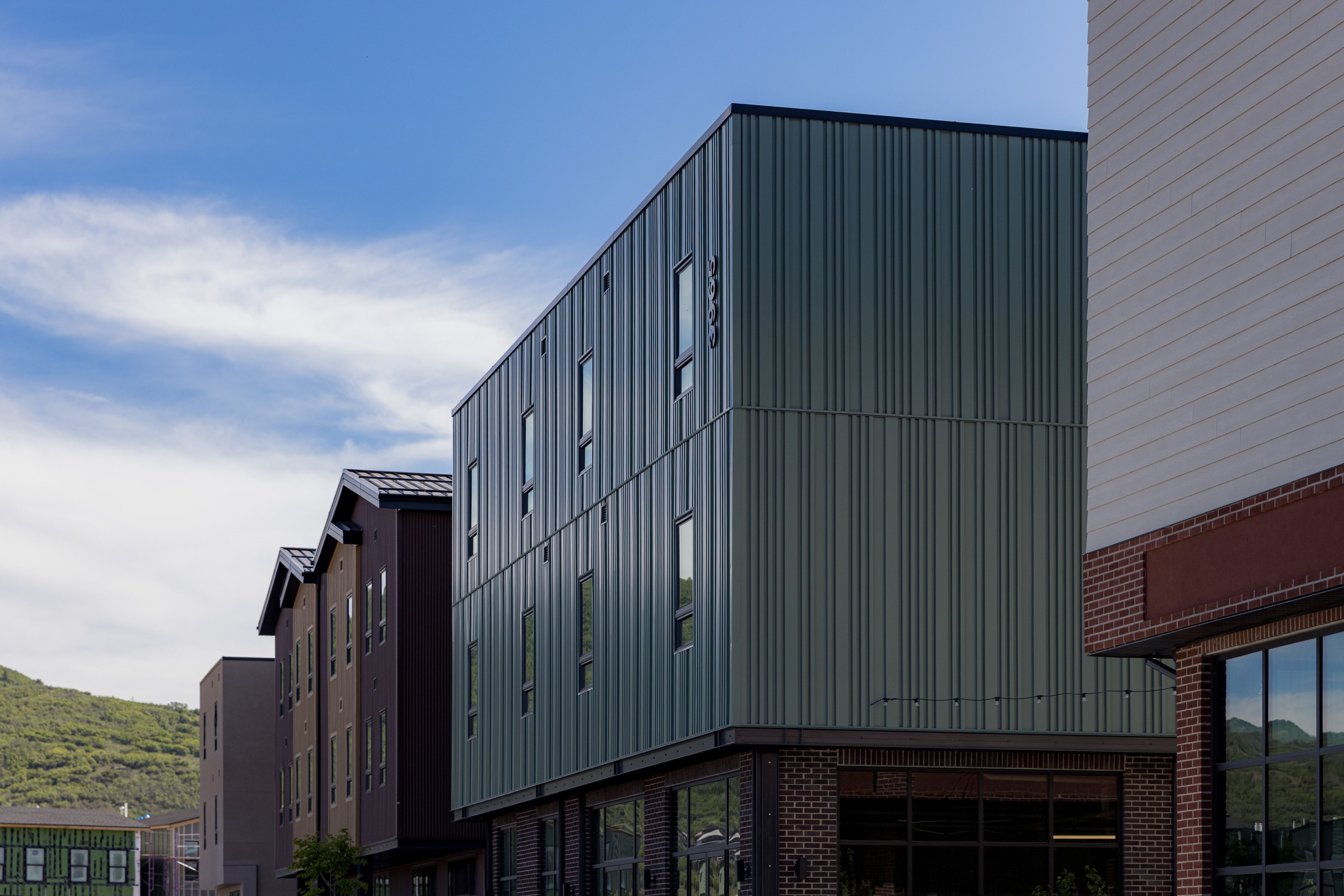 Modern building exterior featuring a vertical metal panel facade