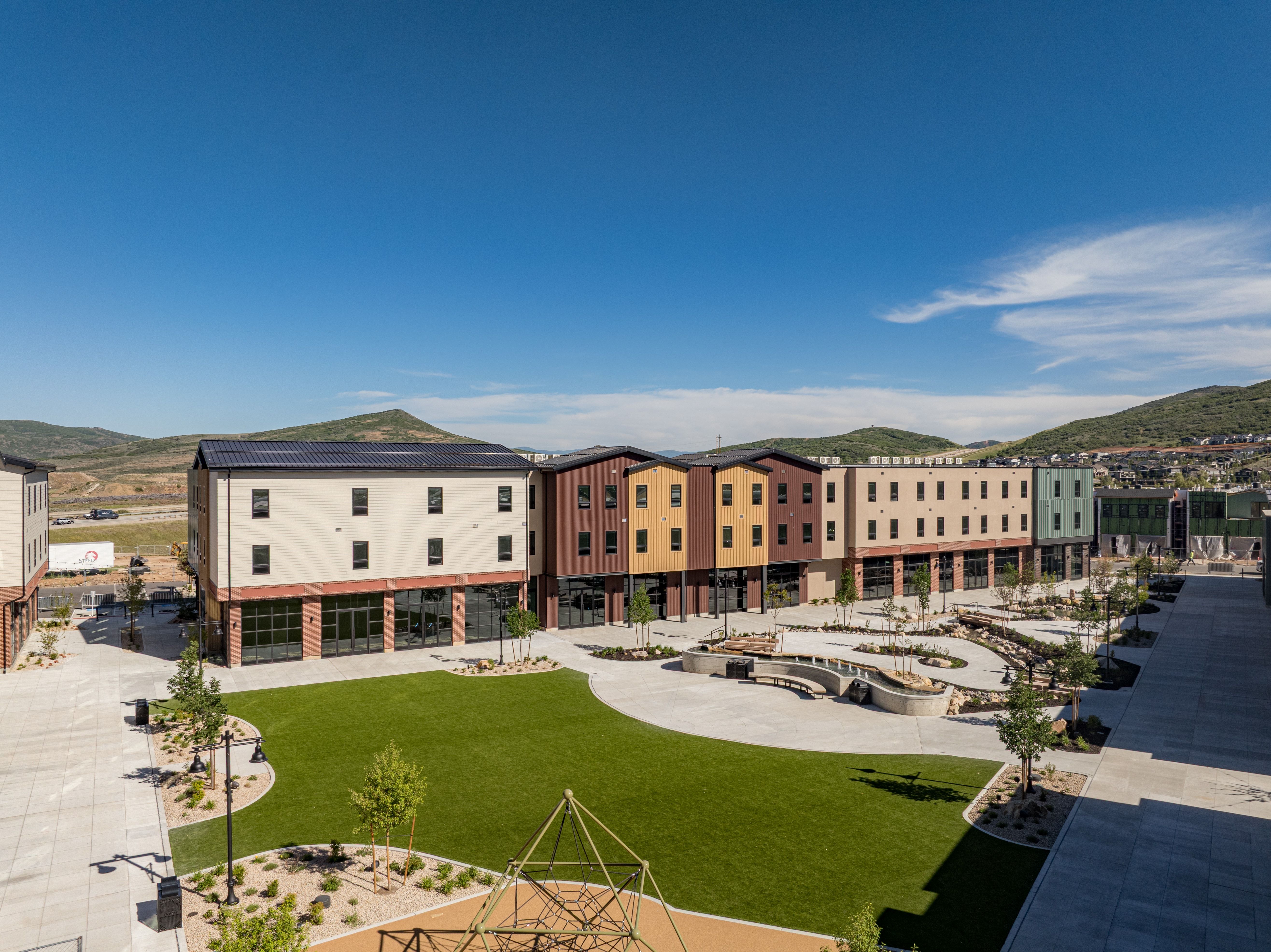 Contemporary multi-story buildings featuring varied facades and ground-level storefronts
